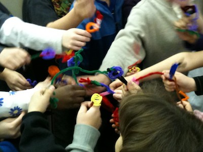 Students making pipe-cleaner neurons.